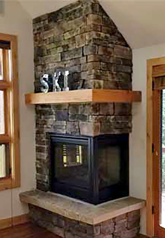 Gas fireplace replaced a wood burning fireplace that was improperly installed in Big Sky. Mantle and stone work completed by Big sky Chimney.